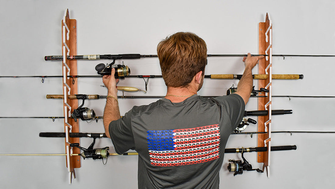 man racking up fishing poles