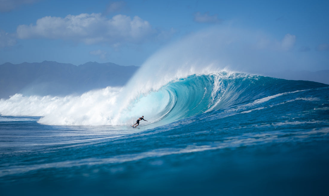 a person surfing a massive wave