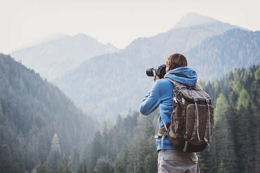 photographer taking pictures of mountains