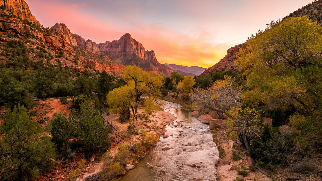 mountains with a river at sunset