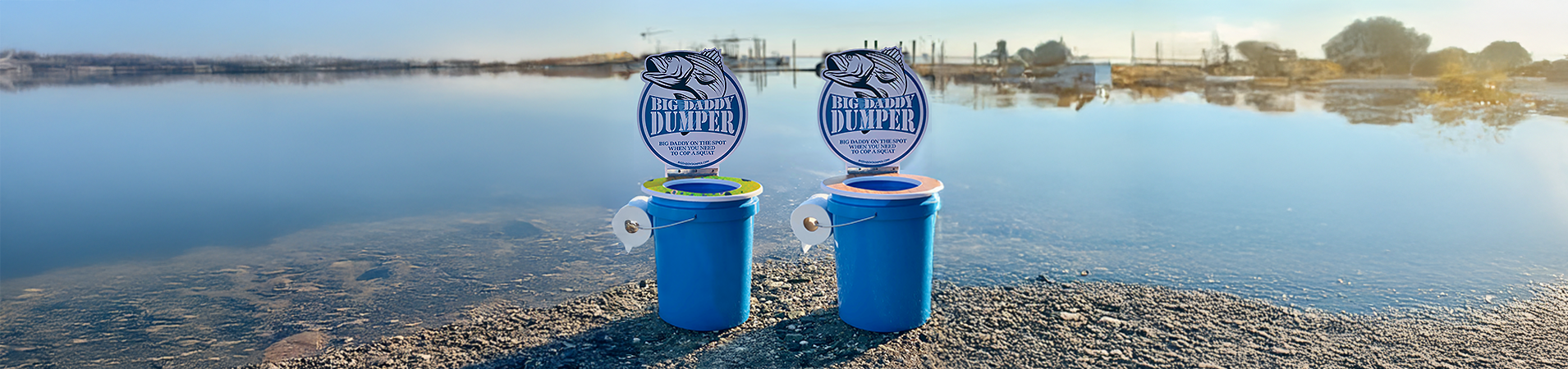 two portable pottys sitting on the edge of the lake
