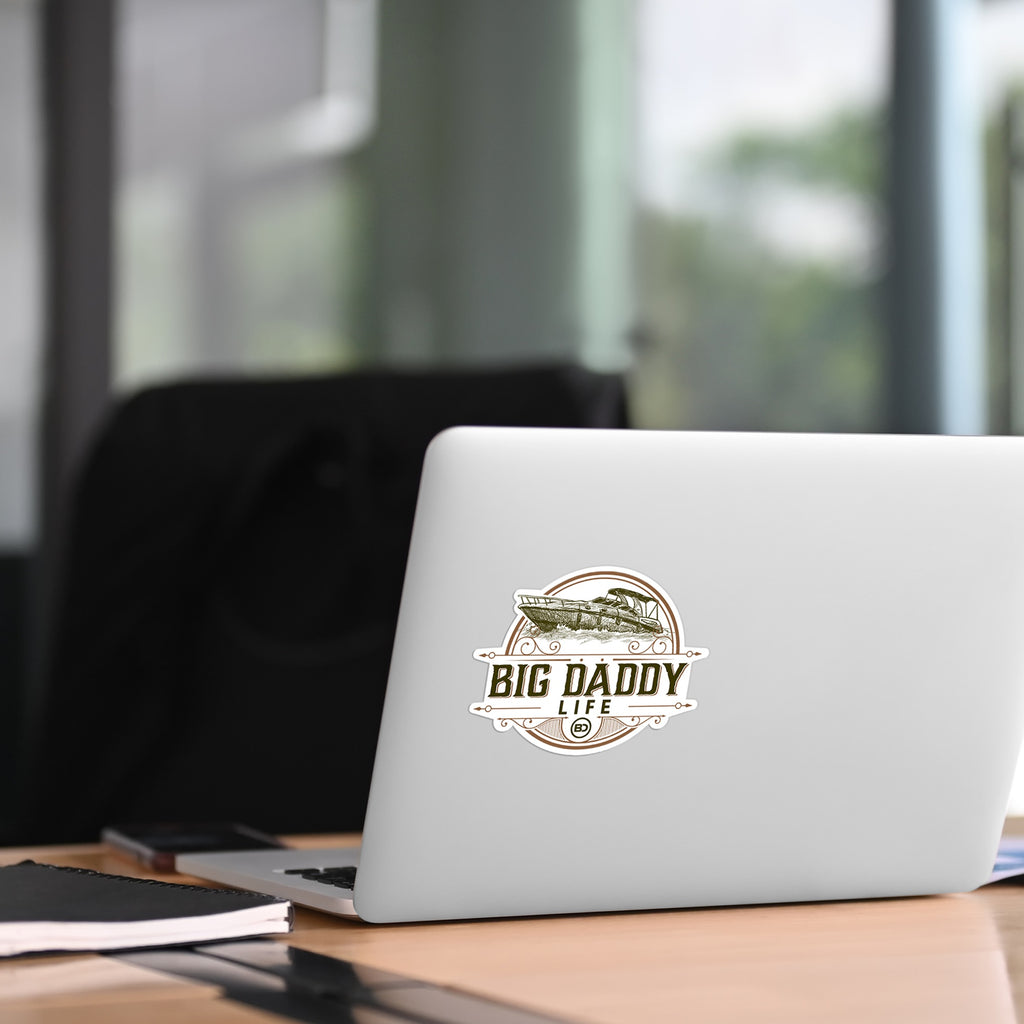 Laptop with 'BIG DADDY LIFE' sticker on a desk in an office setting
