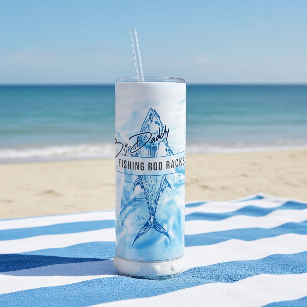 speaker tumber sitting on  a towel thats on the beach