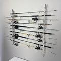 Wall-mounted fishing rod holder with multiple fishing rods on a gray wall.